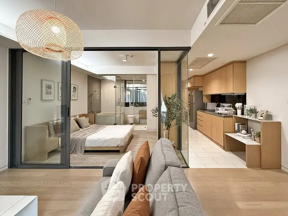 Modern open-plan apartment with stylish kitchen and cozy bedroom