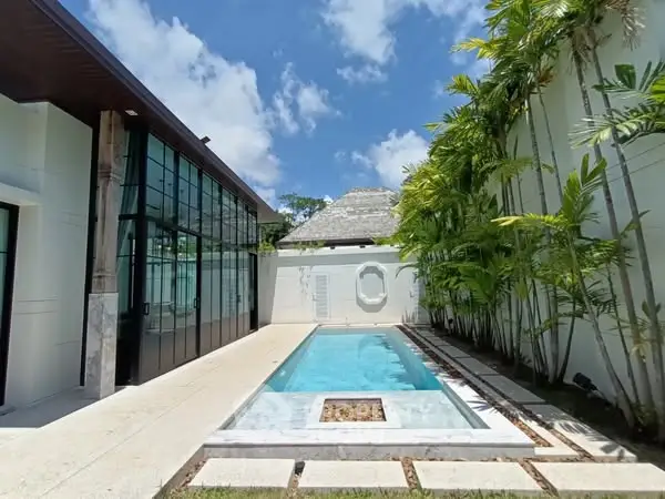 Luxurious modern villa with private pool and lush greenery, perfect for tropical living.