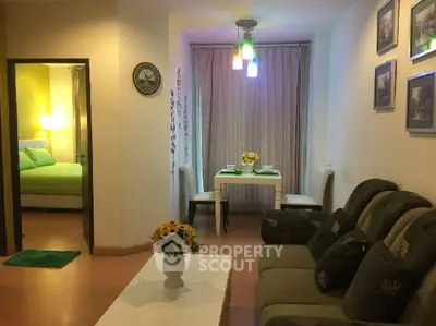 Cozy living room with elegant decor and adjacent dining area in modern apartment.