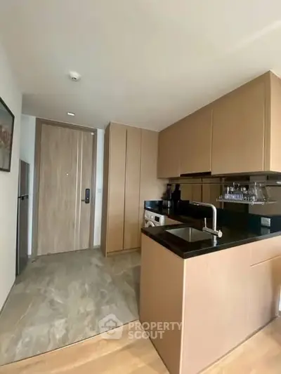 Modern compact kitchen with sleek cabinetry and open layout in a stylish apartment.