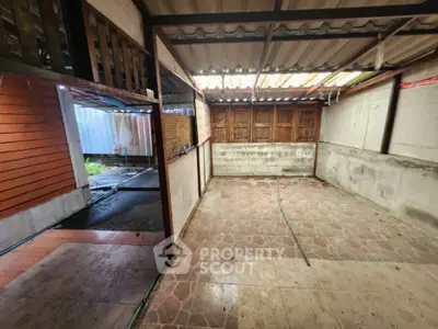 Spacious unfinished room with tiled floor and wooden accents, ideal for customization.