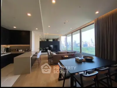 Luxurious open-plan living room with stunning city view and modern kitchen.