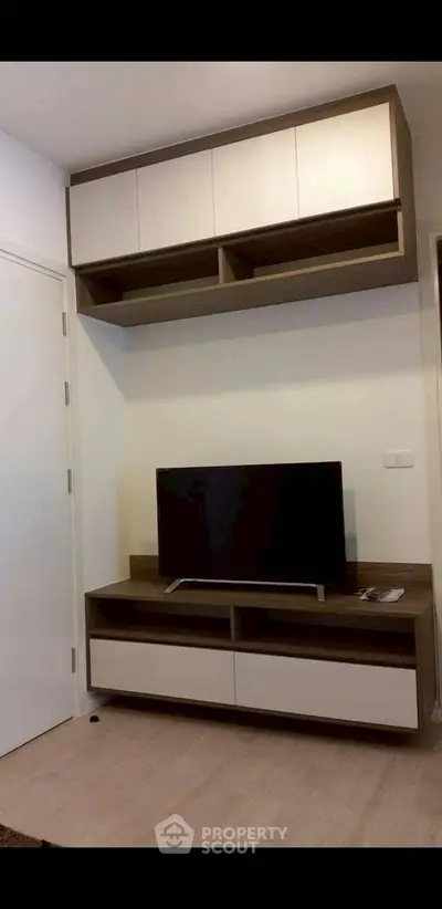 Modern living room with sleek TV unit and ample storage space
