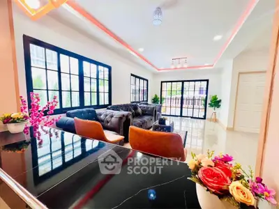 Luxurious living room with elegant sofas and large windows, perfect for relaxation.