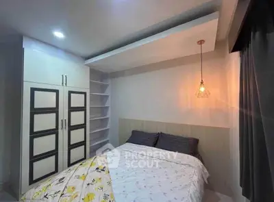 Cozy bedroom with modern lighting and ample storage space