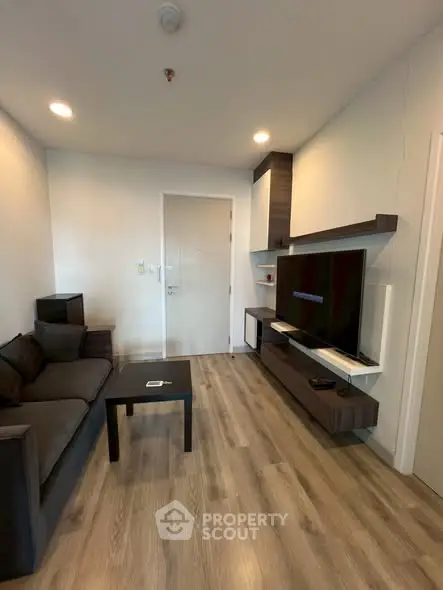 Modern living room with sleek furniture and wall-mounted TV