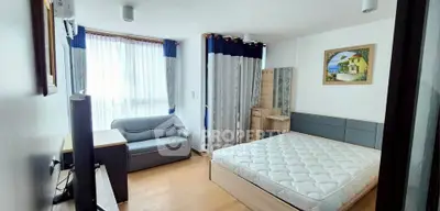 Bright and cozy bedroom with modern furnishings and large window for natural light.