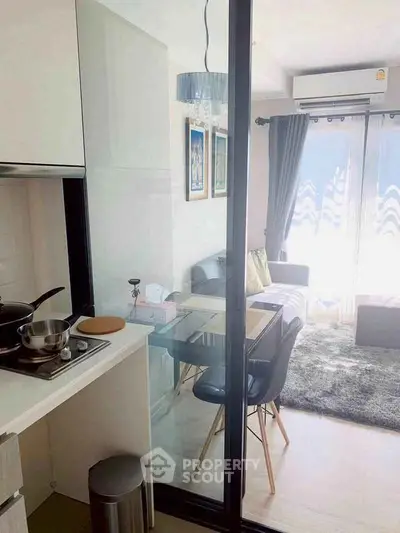 Modern open-layout kitchen and living room with stylish decor and natural light