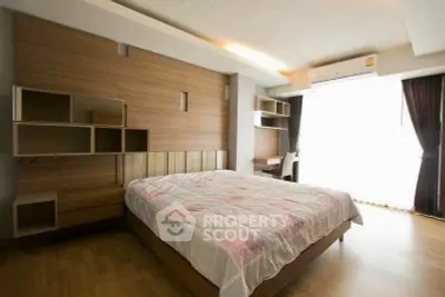 Spacious modern bedroom with wooden accents and natural light