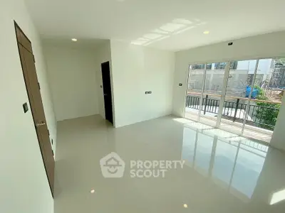 Spacious empty room with large windows and balcony access, perfect for customization.