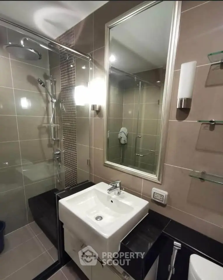 Modern bathroom with sleek fixtures and glass shower enclosure