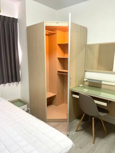 Modern bedroom with built-in corner wardrobe and sleek desk setup