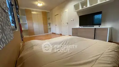 Spacious bedroom with modern furniture and ample storage space