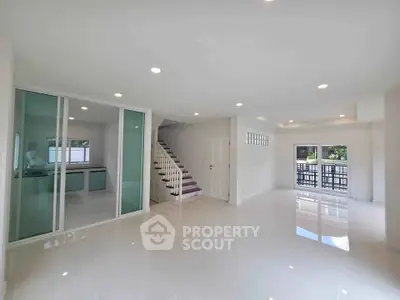 Spacious modern living room with open layout and large windows for natural light.