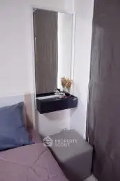 Cozy bedroom corner with modern vanity and plush bedding