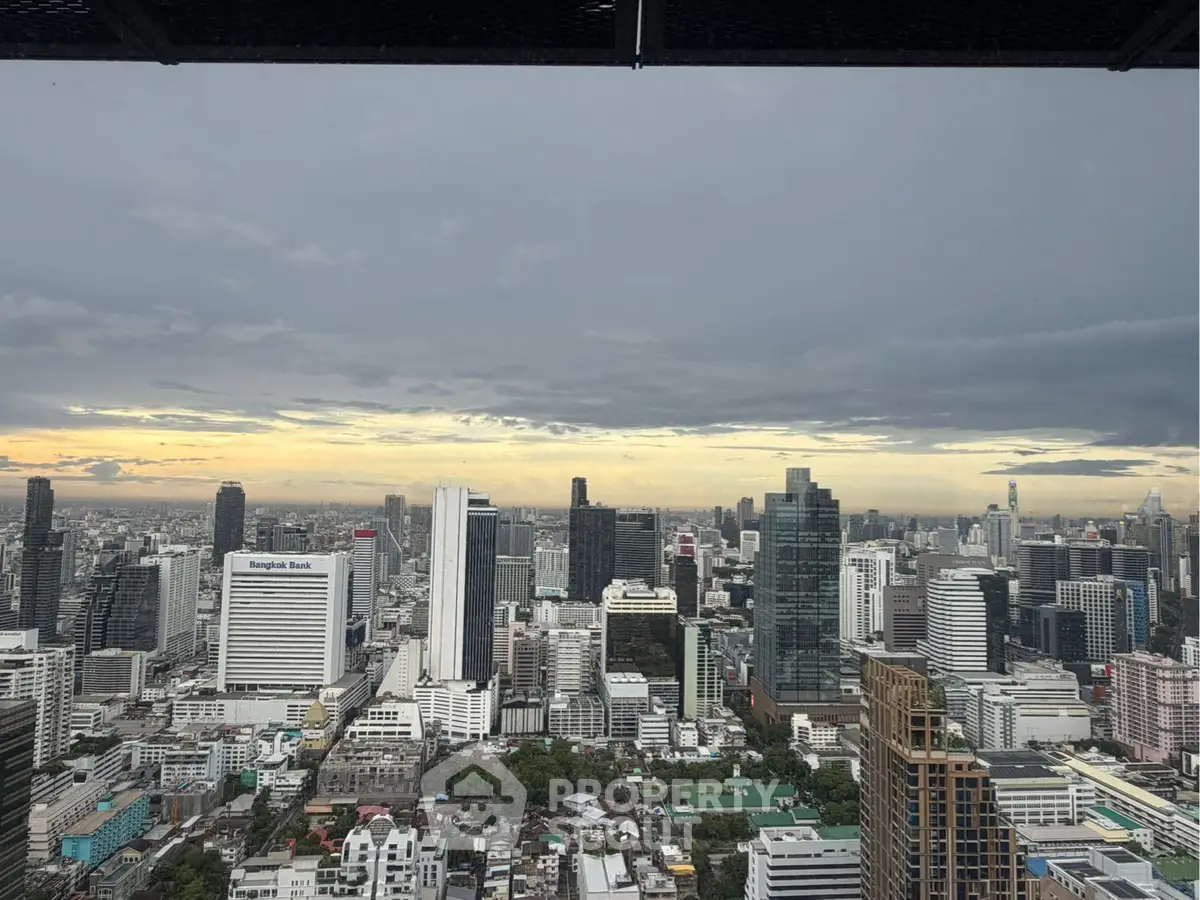 Stunning cityscape view from a high-rise building showcasing urban skyline at sunset.