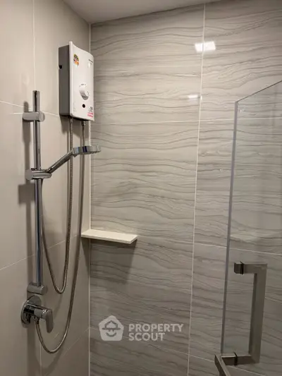 Modern bathroom with sleek shower and elegant tile design, perfect for a contemporary home.