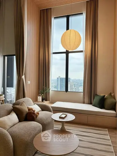 Luxurious living room with tall windows and modern decor in high-rise apartment