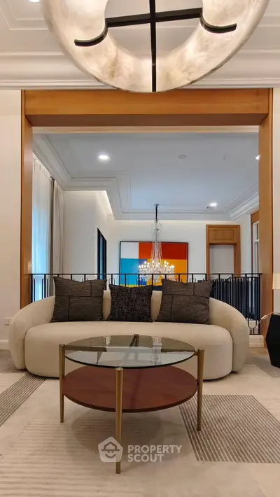 Luxurious living room with modern sofa, elegant chandelier, and stylish decor in a sophisticated setting.