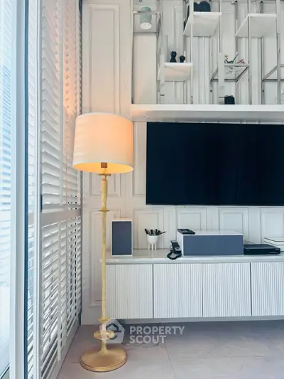 Modern living room with elegant floor lamp and sleek entertainment center