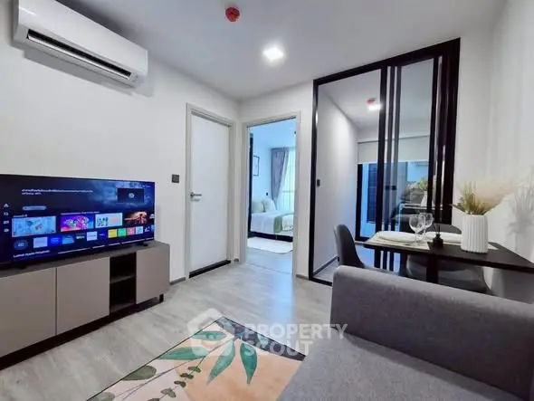 Modern living room with TV and dining area in stylish apartment