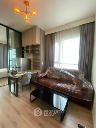 Modern living room with stylish furniture and large windows in a contemporary apartment.
