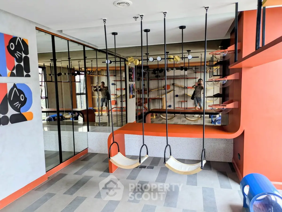 Stylish modern gym with unique swing seating and mirrored walls