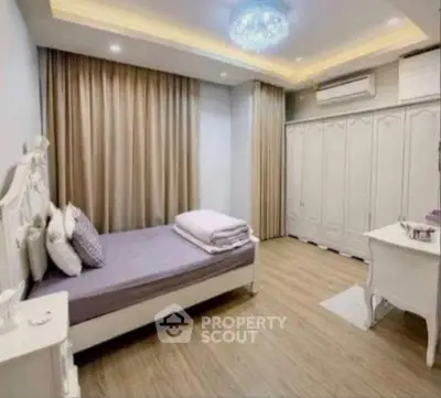 Elegant bedroom with modern lighting and ample storage in a stylish real estate property.