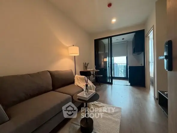 Modern living room with cozy sofa and balcony view in stylish apartment.