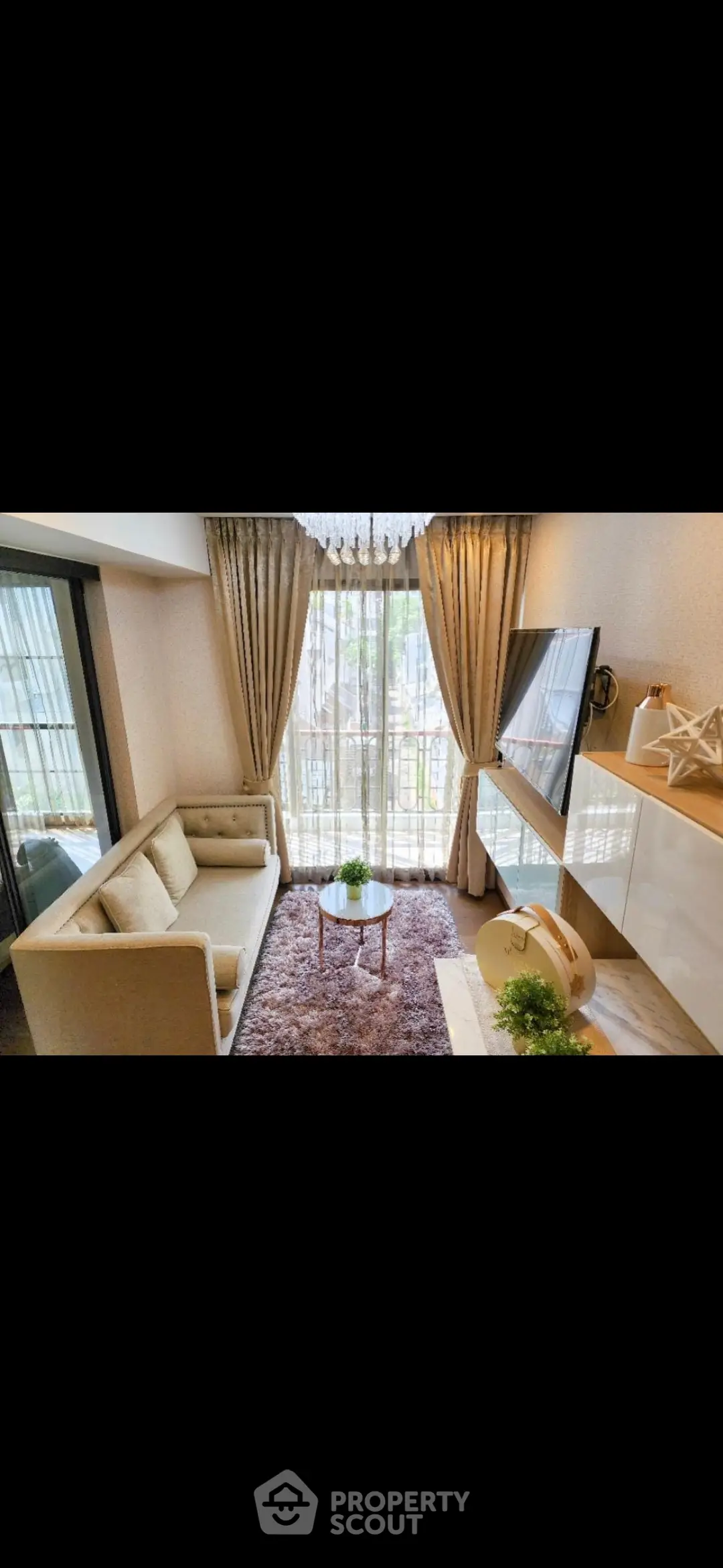 Chic modern living room with elegant decor and large windows offering natural light.