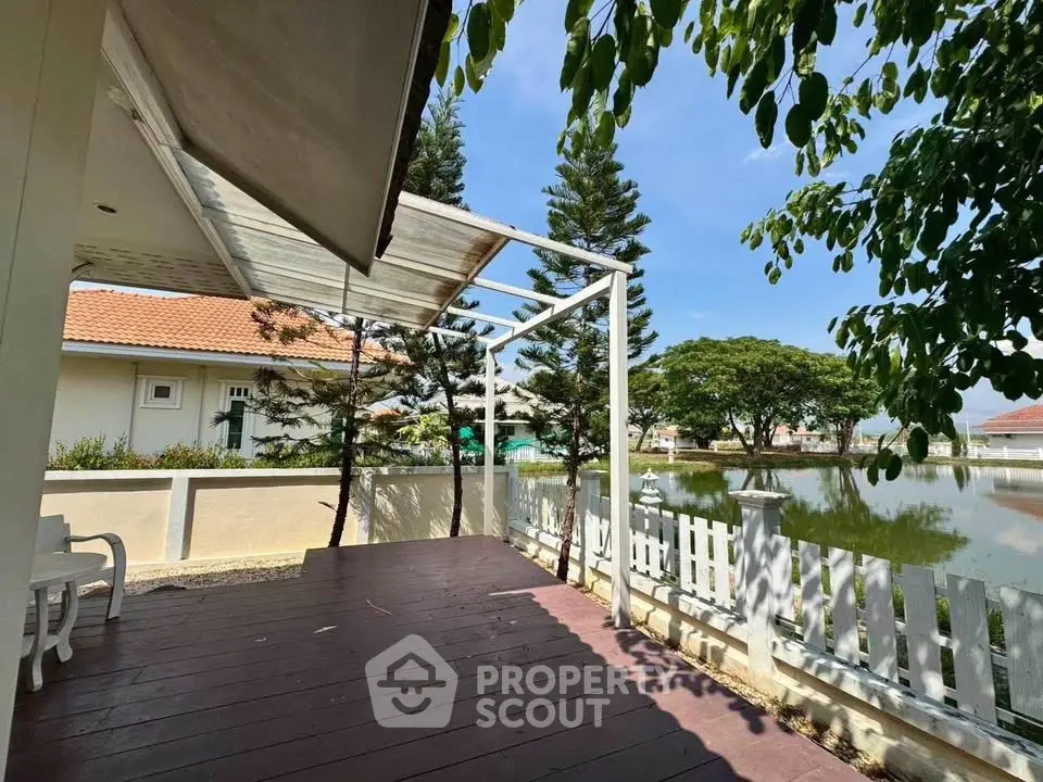 Charming lakeside patio with wooden deck and scenic view, perfect for relaxation and outdoor gatherings.
