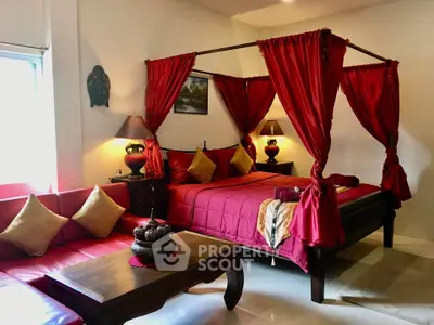 Luxurious bedroom with elegant four-poster bed and vibrant red decor