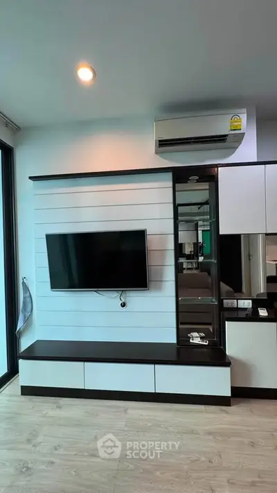 Modern living room with sleek TV unit and air conditioning, perfect for contemporary living.