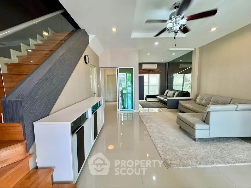 Spacious modern living room with sleek staircase and elegant furniture