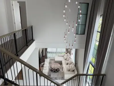 Luxurious modern living room with high ceilings and elegant chandelier