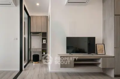 Modern living room with sleek TV unit and stylish decor in a contemporary apartment.