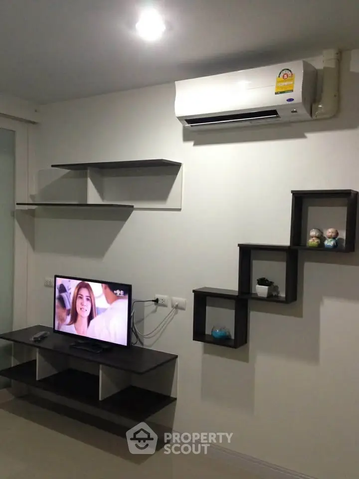 Modern living room with sleek shelving and wall-mounted air conditioner, perfect for stylish urban living.