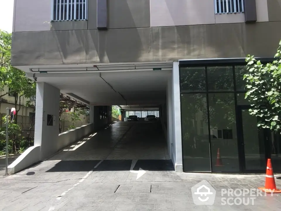 Modern building entrance with covered parking and sleek design