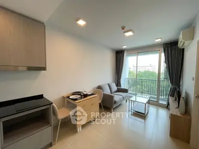 Modern living room with balcony view and stylish furniture in a bright apartment.