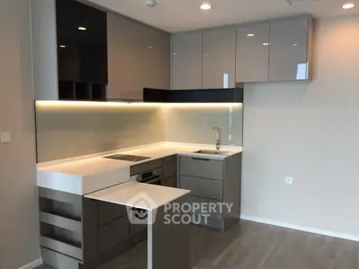 Modern kitchen with sleek cabinetry and integrated appliances in a stylish apartment.
