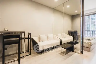 Modern living room with mirrored wall and sleek furniture in a stylish apartment