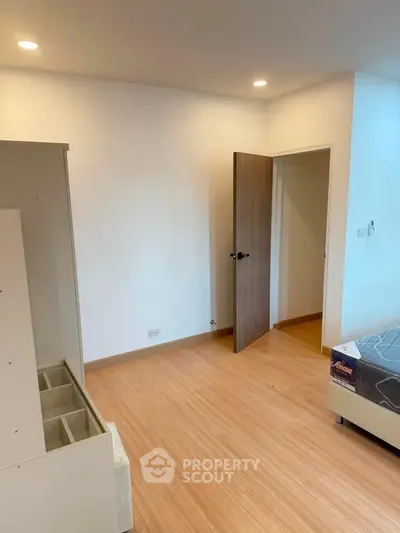 Modern bedroom with wooden flooring and minimalist design