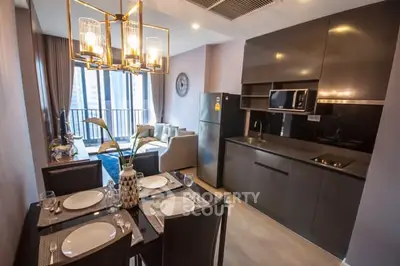 Modern kitchen and living area with sleek design and dining setup.