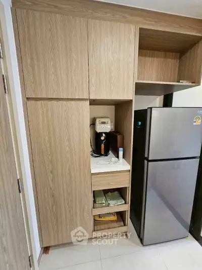 Modern kitchen with sleek wooden cabinets and stainless steel fridge