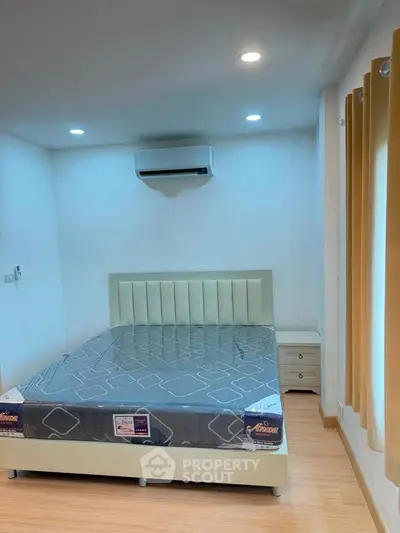 Modern bedroom with air conditioning and stylish bed in a cozy apartment.
