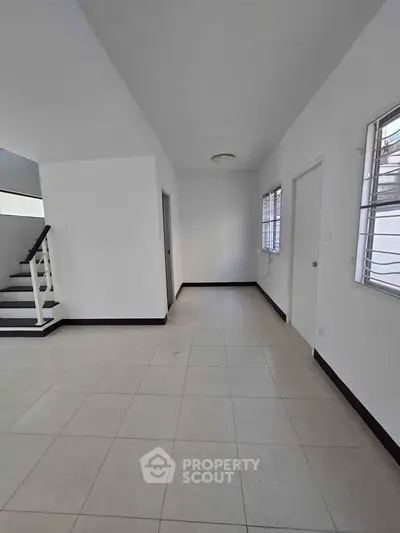 Spacious interior with tiled flooring and natural light, perfect for customization.