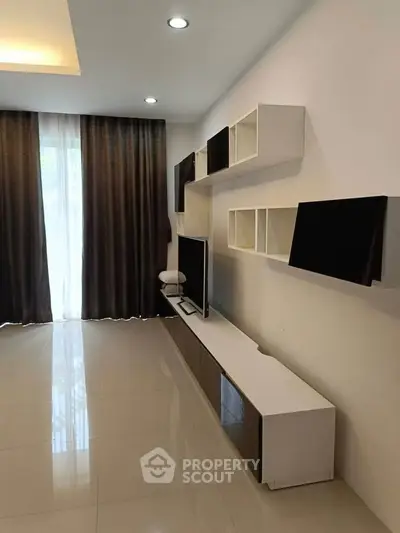 Modern living room with sleek TV unit and stylish shelving