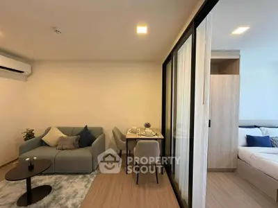 Modern living room with cozy seating and dining area in open-plan apartment.