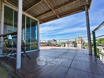 Spacious balcony with city view, perfect for relaxation and outdoor dining.