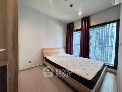 Modern bedroom with large window and minimalist design in urban apartment